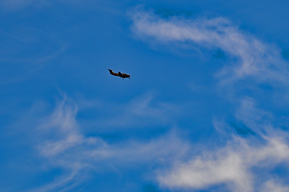 Picture of a small passenger plane in some fluffy clouds