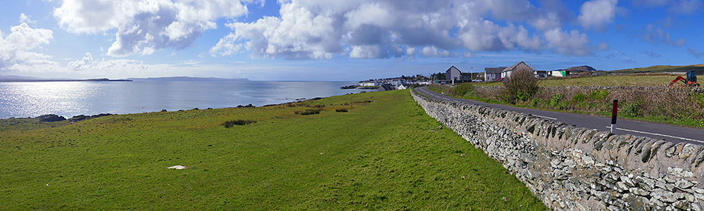 Panoramic picture of sea loch with a village on the shore