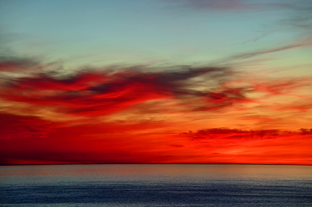 Picture of some very colourful gloaming after sunset in the west over the sea seen from the shore
