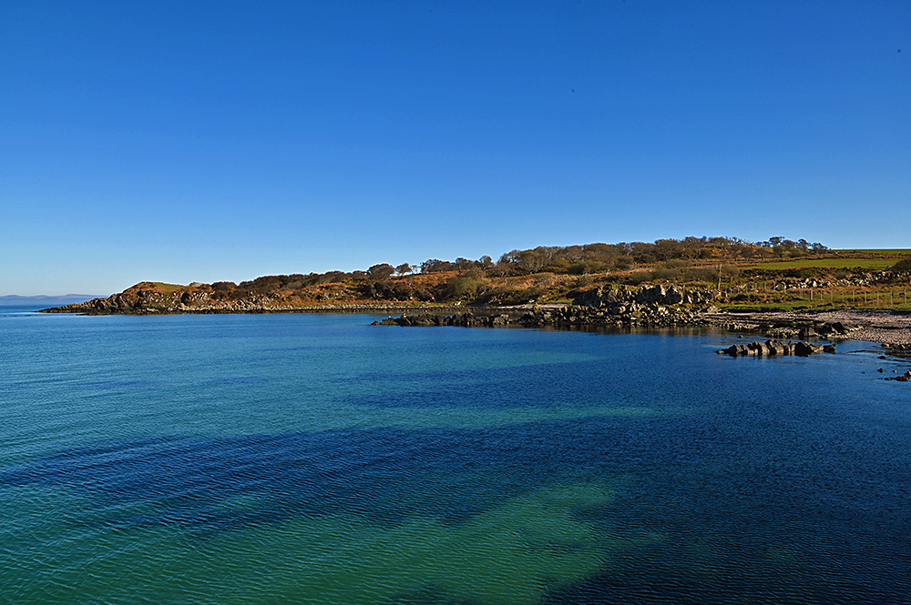 Picture of the coastline of a small bay in beautiful mild April afternoon sunshine