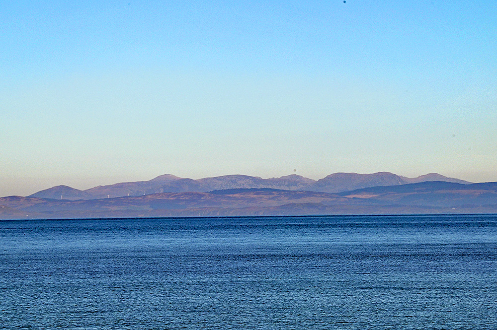 A view from Claggain Bay on the south east corner of Islay, looking over the Sound of Jura to the mainland with Kintyre, behind it the hills of the Isle of Arran