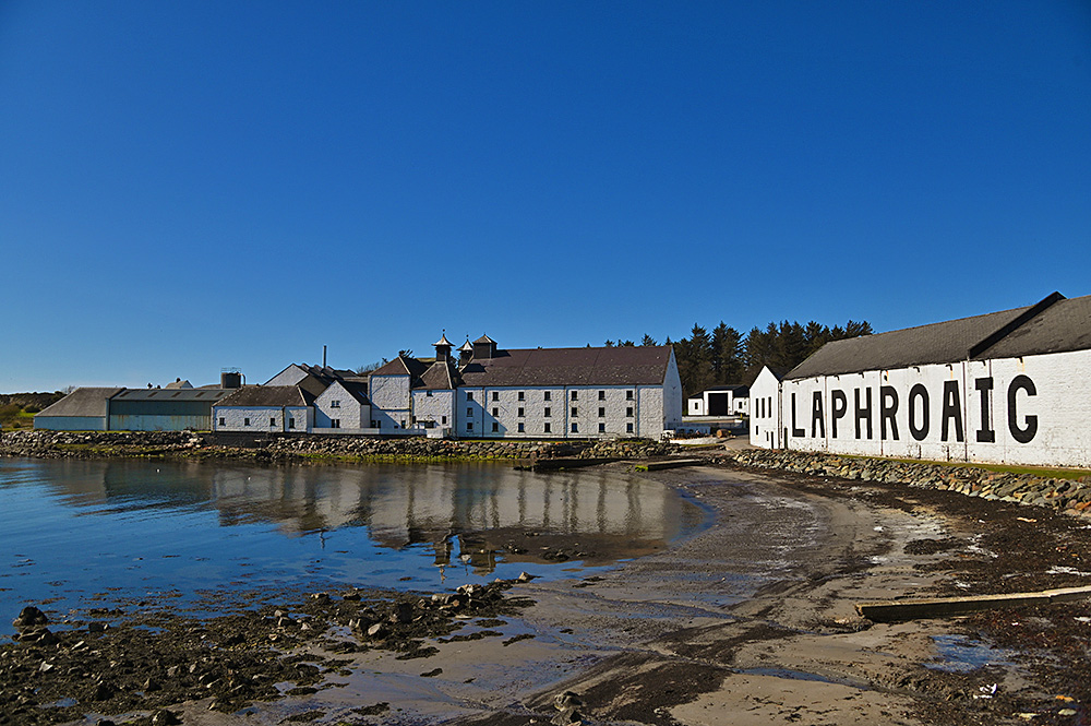 Picture of white washed distillery (Laphroaig on Islay) buildings in beautiful April sunshine under blue skies