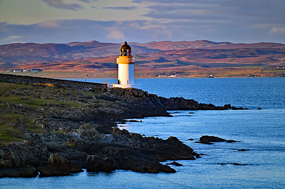 Picture of a small coastal lighthouse in some beautiful April evening sunshine at a sea loch