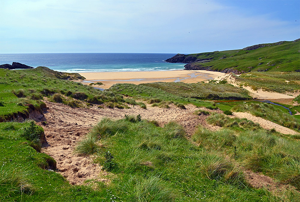 Picture of view from dunes over a sandy beach in a small bay